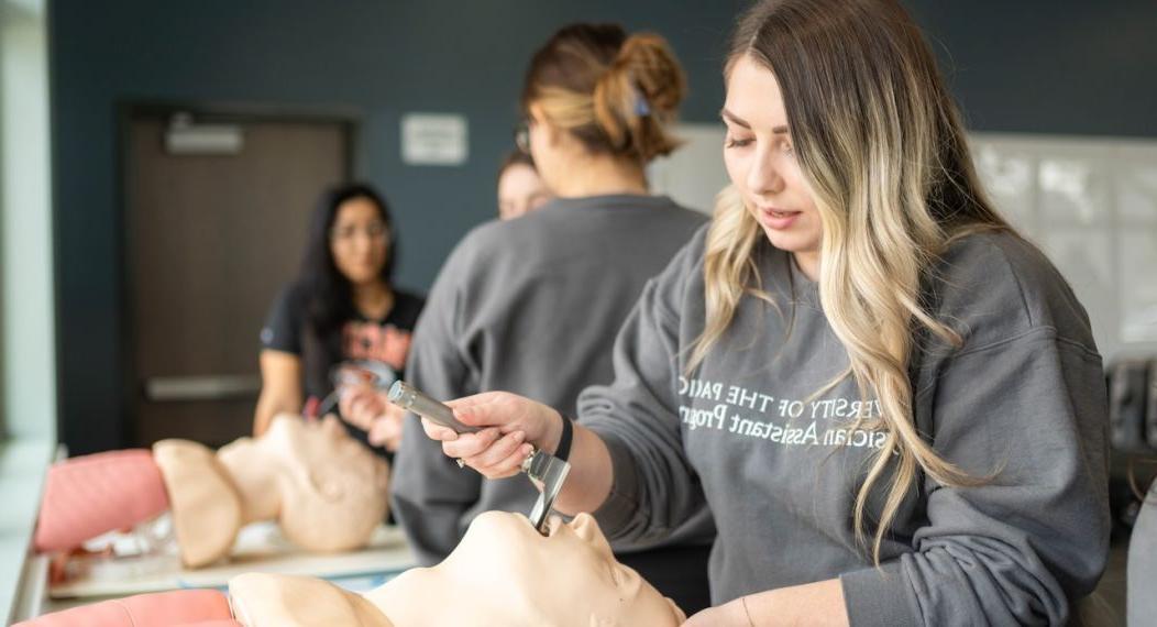 Image shows students practicing procedures on mannequins